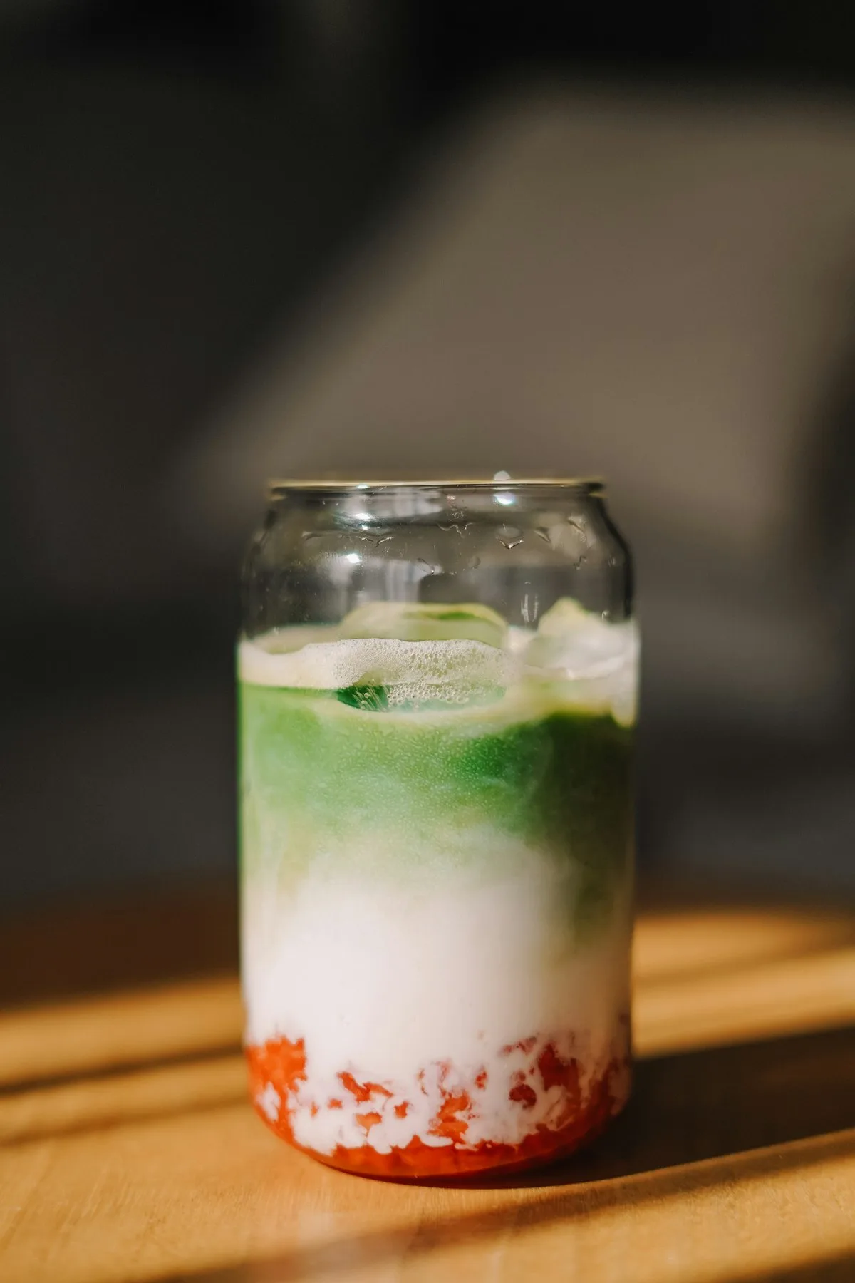 Layered berry matcha latte in a glass