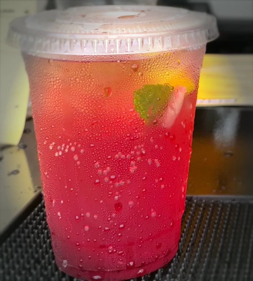 Ruby Sunset — a deep ruby-red iced mocktail in a clear cup
